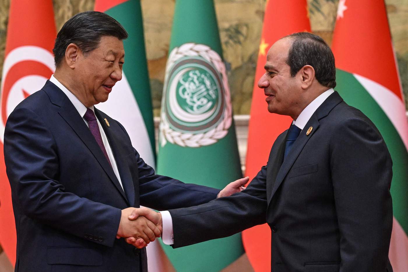 China’s President Xi Jinping (L) shakes hands with Egypt’s President Abdel Fattah El-Sisi in Beijing on May 30, 2024. (AFP)