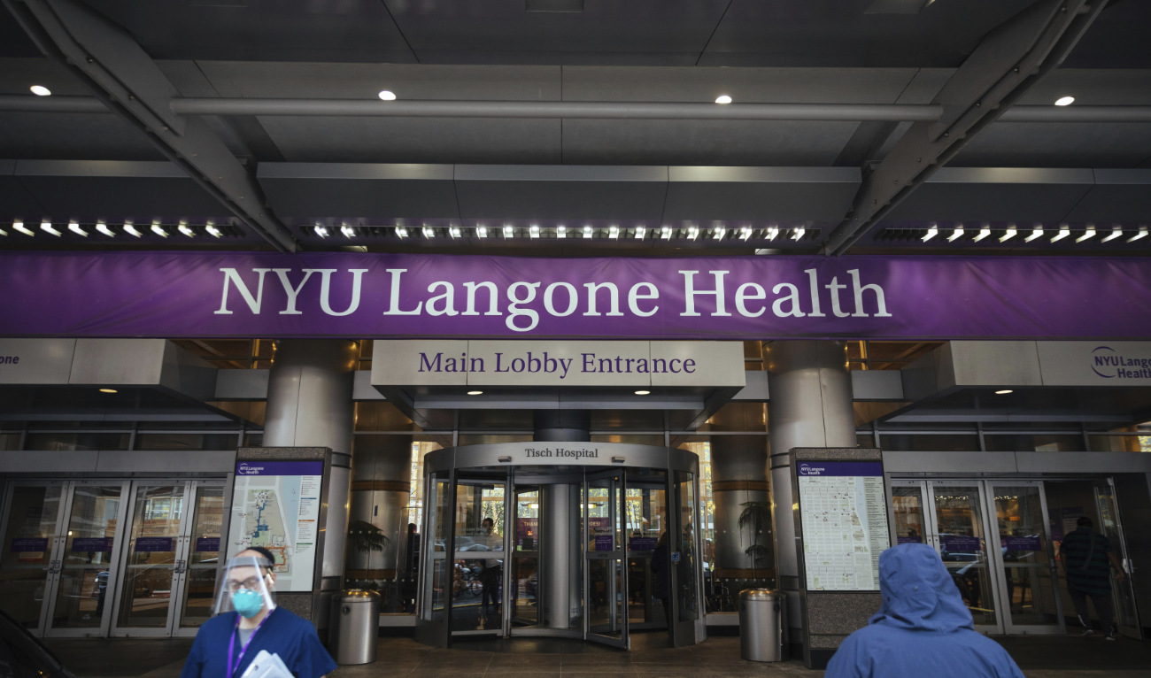 Health care workers walk in and out of the entrance at NYU-Langone Hospital on Monday, Dec. 14, 2020, in New York. A nurse was fired by the hospital after she referred to Israel’s war in Gaza as “genocide” during a speech accepting an award. (AP/File)