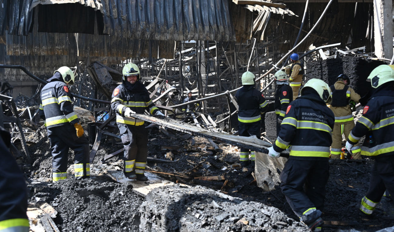 Employees of the State Emergency Service of Ukraine sort out the debris in a hardware supermarket in Kharkiv destroyed by a Russian strike, on May 26, 2024. (AFP/File)