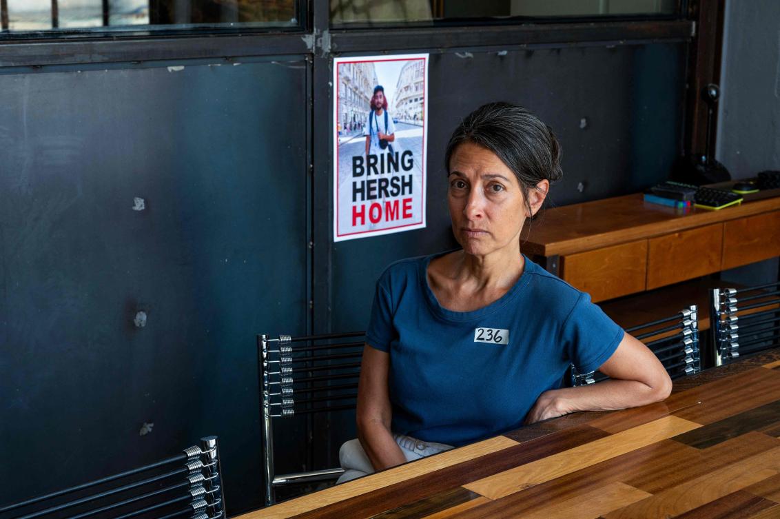 Rachel Goldberg-Polin, the mother of Hersh Goldberg-Polin, who has been held hostage by the Palestinian militant group Hamas, poses for a photo next to a poster of her son during an interview in Jerusalem on May 29, 2024. (AFP)