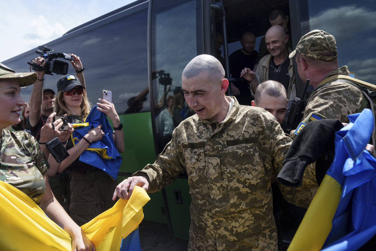 A Ukrainian serviceman reacts after returning from captivity during POWs exchange in Sumy region, Ukraine, on May 31, 2024. (AP)