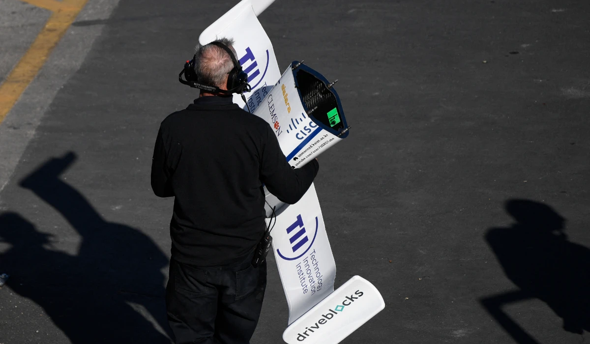 A crew member carries the front nose wing of the KAIST autonomous race car in Las Vegas, Nevada. (AFP)