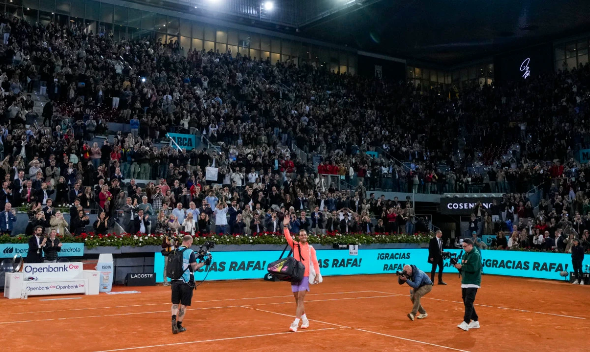 Rafael Nadal, of Spain, center, waves to the crowd after losing a match against Jiri Lehecka, of Czech Republic, during the Mutua Madrid Open tennis tournament in Madrid, Tuesday. (AP)