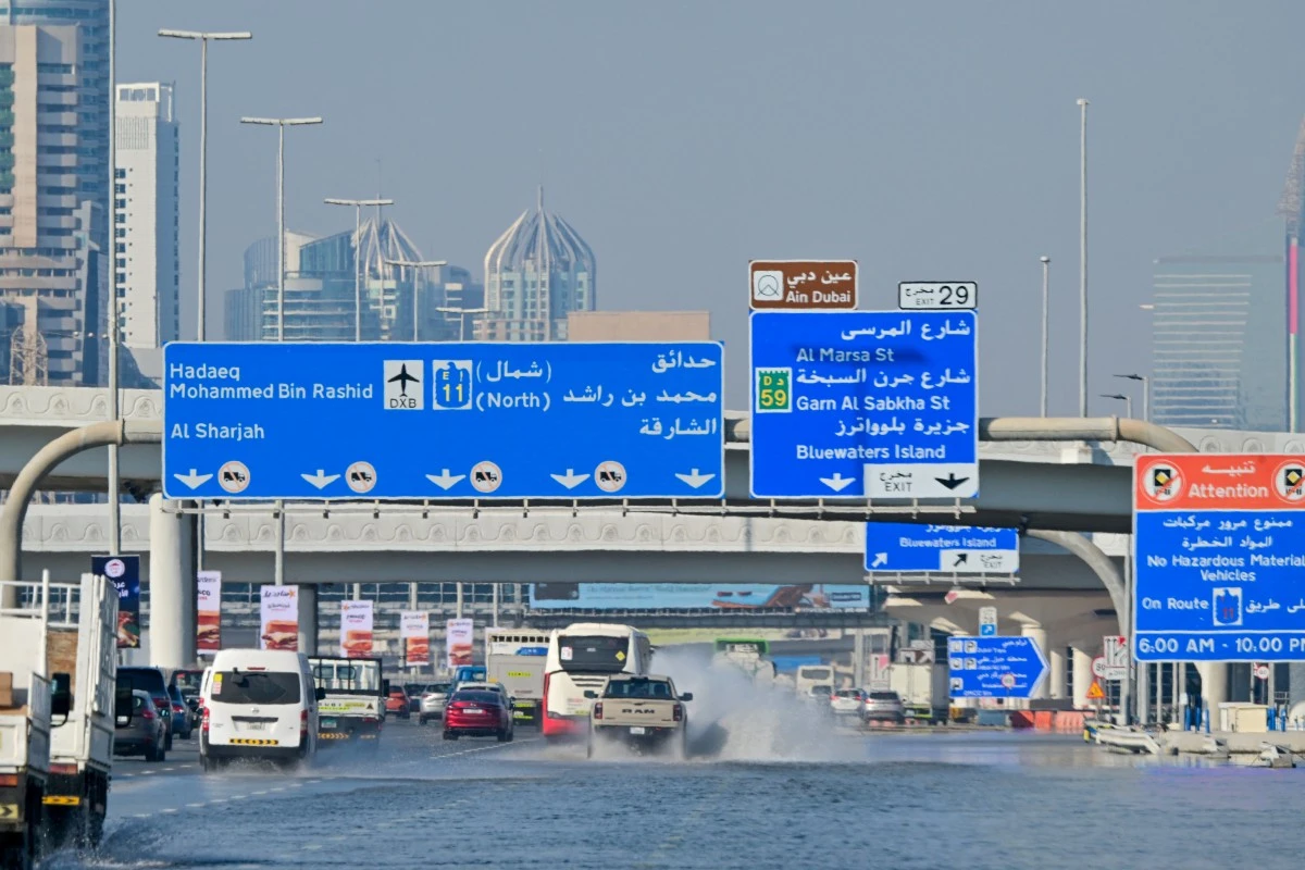 Cars drive down a flooded motorway in Dubai on April 20, 2024. (AFP)