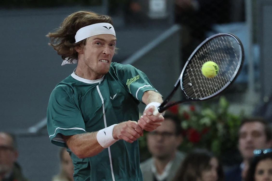 Russia’s Andrey Rublev returns the ball to Spain’s Carlos Alcaraz during the 2024 ATP Tour Madrid Open tournament quarter-final match at Caja Magica in Madrid on May 1, 2024. (AFP)