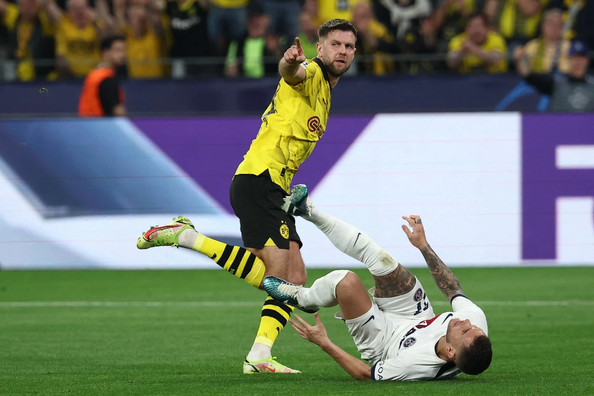 Dortmund's German forward Niclas Fuellkrug celebrates scoring the opening goal as Paris Saint-Germain's French defender Lucas Hernandez reacts during their UEFA Champions League semifinal first leg in Dortmund, western Germany on May 1, 2024. (AFP)