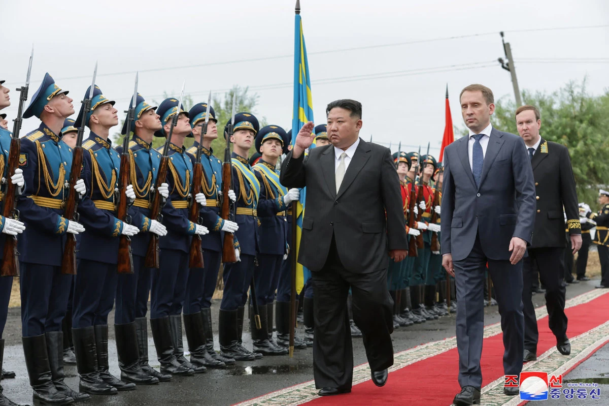 North Korea's leader Kim Jong Un (C) and Russia's Minister of Natural Resources and Environment Alexander Kozlov (R) attend a farewell ceremony for the Russian minister at the end of his visit to Russia, at Artyom railway station near Vladivostok, Primorsky region. (KCNA VIA KNS / AFP)