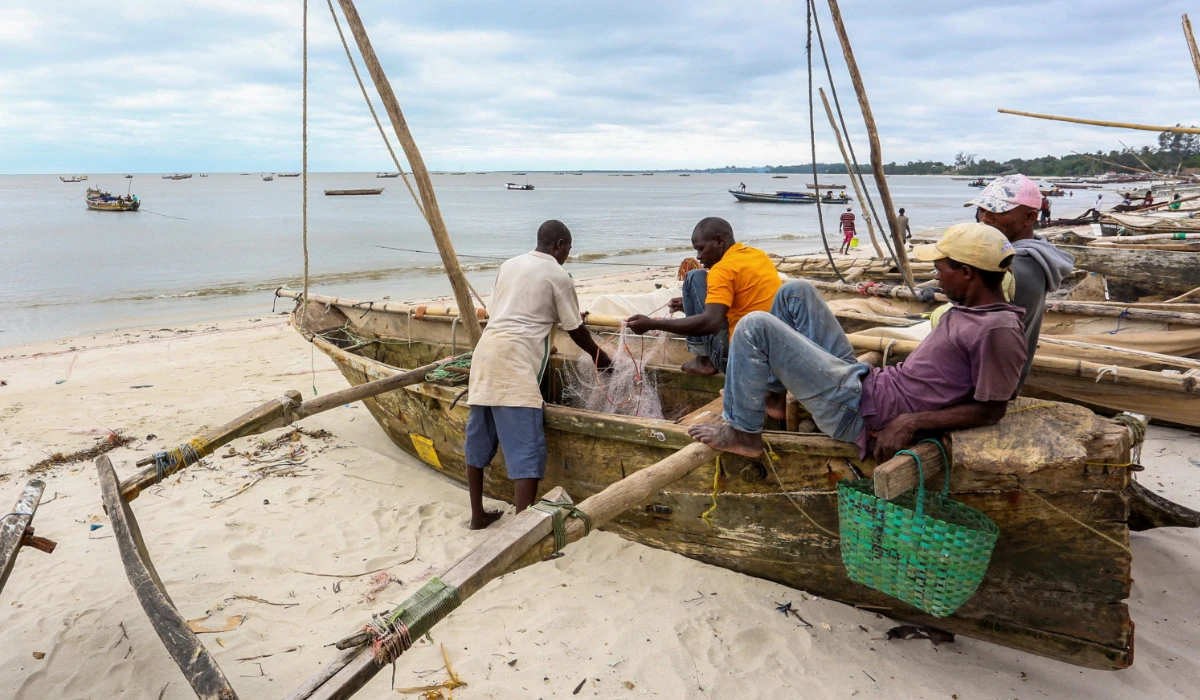 Tanzanian fishermen sit on their boats on the shores of the Indian Ocean as they prepare for the effects of tropical cyclone Hidaya in Bagamoyo District in the Coast region, Tanzania May 4, 2024. (REUTERS)