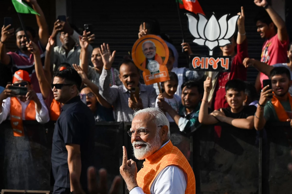 India's Prime Minister Narendra Modi displays his inked marked finger after casting his ballot in Ahmedabad on May 7, 2024. (AFP)