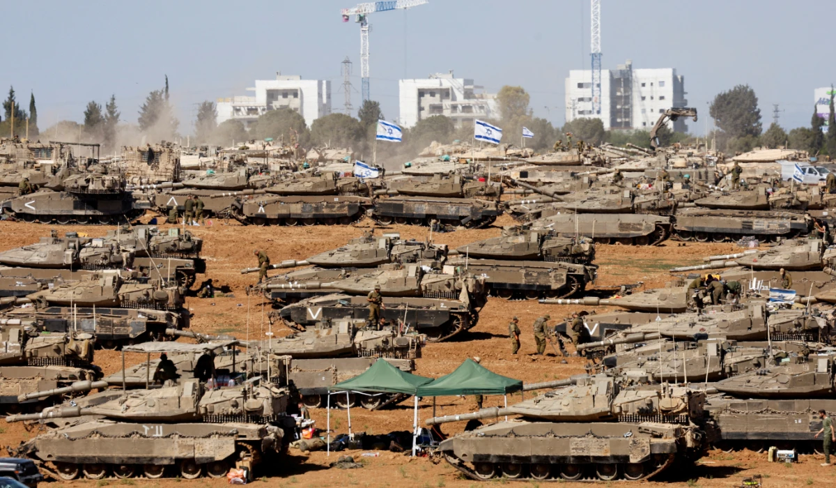 Israeli soldiers stand next to military vehicles, amid the ongoing conflict between Israel and the Palestinian Islamist group Hamas, near the Israel-Gaza Border, in southern Israel, May 7, 2024. (REUTERS)