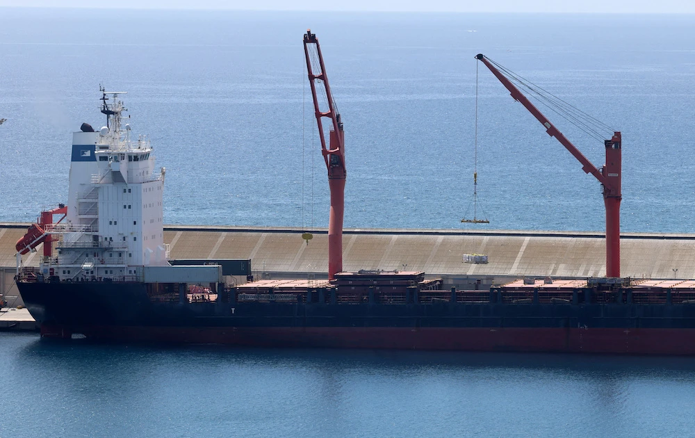 Above, a crane lifts aid supplies onto a cargo vessel at the port of Larnaca, Cyprus on May 8, 2024. The aid for Gaza would be delivered using a US pier built to expedite supplies to the besieged enclave. (Reuters)