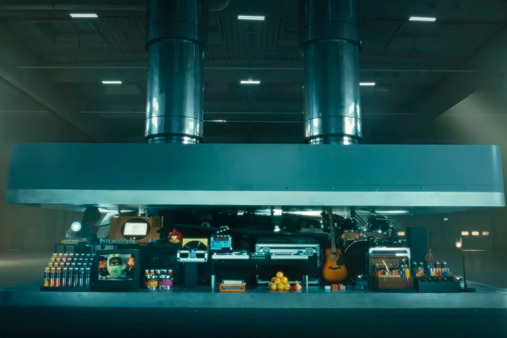 The ad shows a hydraulic press crushes an array of creative instruments. (Apple via AP)