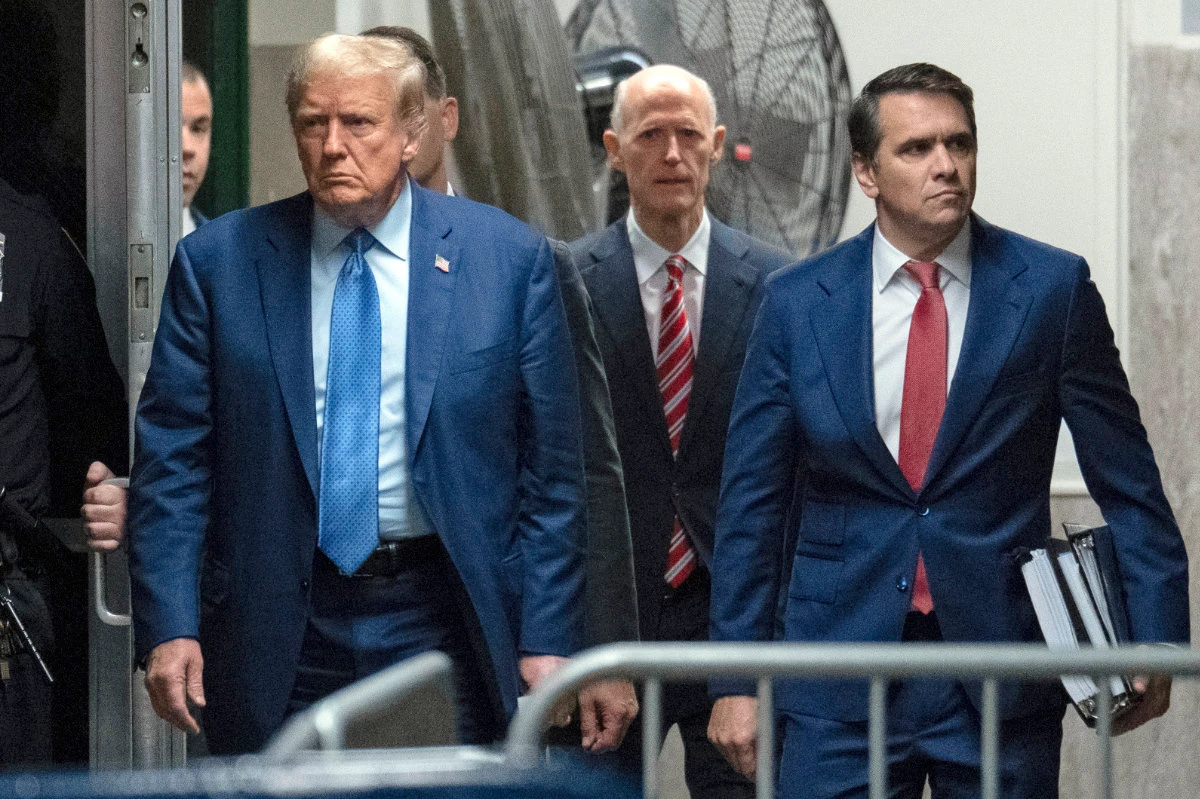 US Sen Rick Scott, rear center, showed up on May 9, 2024, in the trial of former President Donald Trump to show his support, leading to speculations that he was offering himself as a running mate of Trump in the November US presidential election. (Pool Photo via AP)