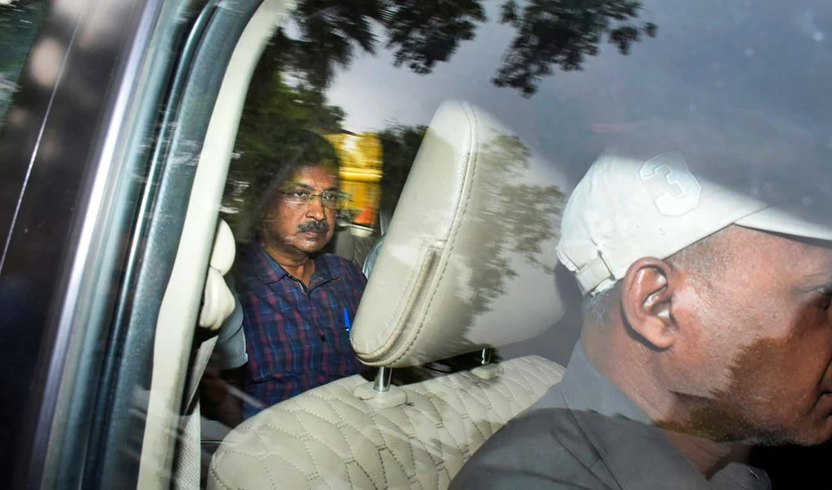 Arvind Kejriwal, leader of the Aam Admi Party, or Common Man's Party, left, leaves in a car after a court extended his custody for four more days, in New Delhi, India, March 28, 2024. India's top court on Friday gave interim bail to the top opposition leader who was arrested nearly seven weeks ago. (AFP/File)
