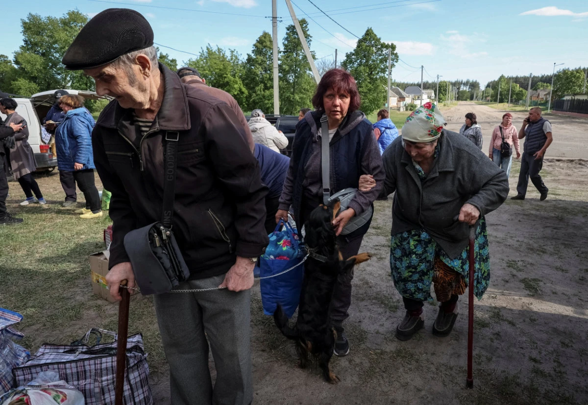 Ukrainian residents from Vovchansk and nearby villages wait for buses amid an evacuation to Kharkiv due to Russian shelling on May 10, 2024. (REUTERS)