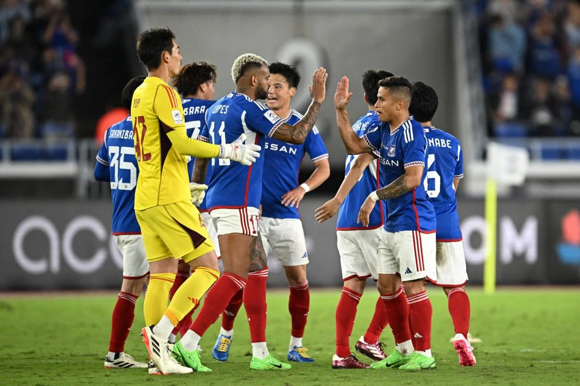 Yokohama celebrate their victory at the end of the AFC Champions League final first leg football match against UAE’s Al-Ain at the Nissan Stadium in Yokohama. (AFP)