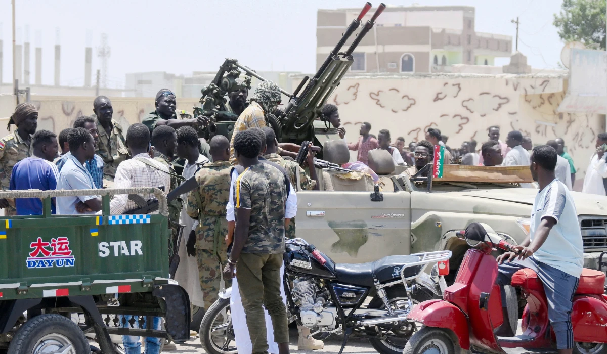 Sudanese greet army soldiers, loyal to army chief Abdel Fattah al-Burhan, in the Red Sea city of Port Sudan on April 16, 2023. (AFP)