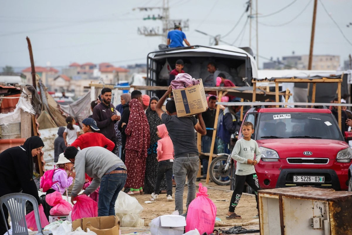 Palestinian pack their belongings as they prepare to flee Rafah in the southern Gaza Strip on May 13, 2024, amid the ongoing conflict between Israel and the Hamas militant group (AFP)
