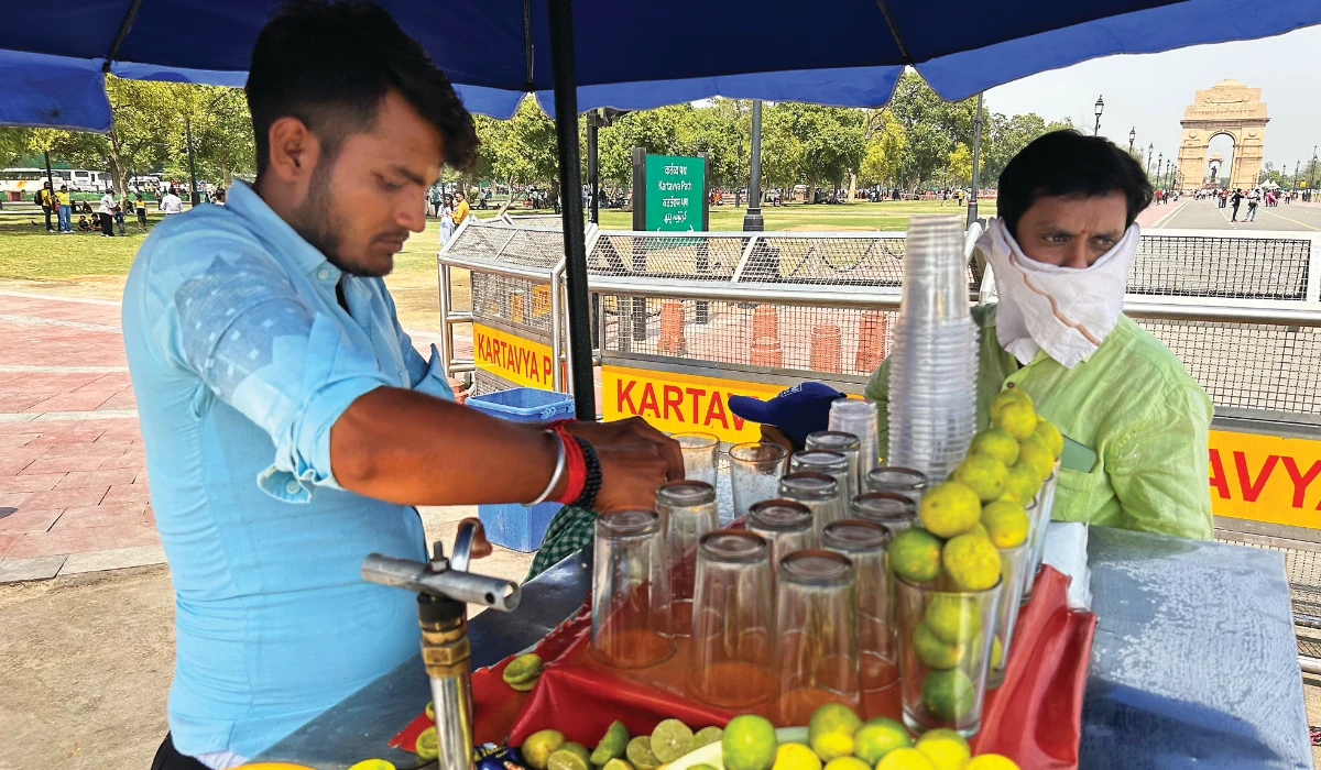 A roadside vendor sells iced lemonade in New Delhi, India, Saturday. (AP)