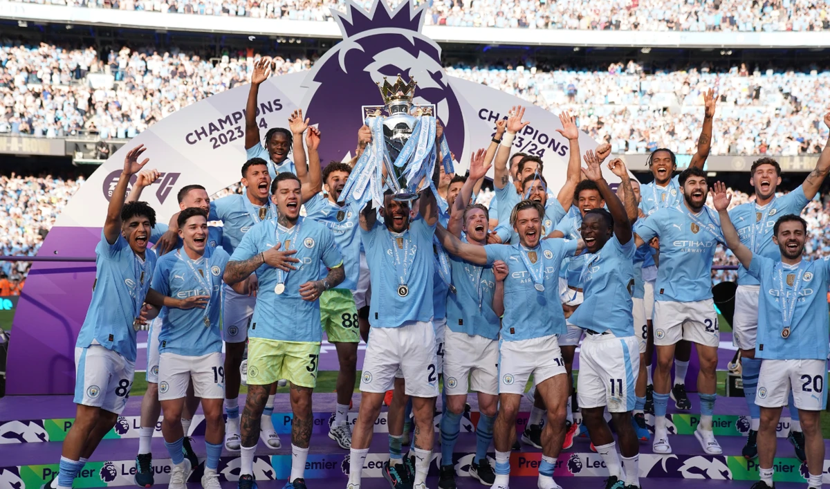 Manchester City players celebrate with the Premier League trophy after the English Premier League match between Manchester City and West Ham United at the Etihad Stadium Sunday. (AP)