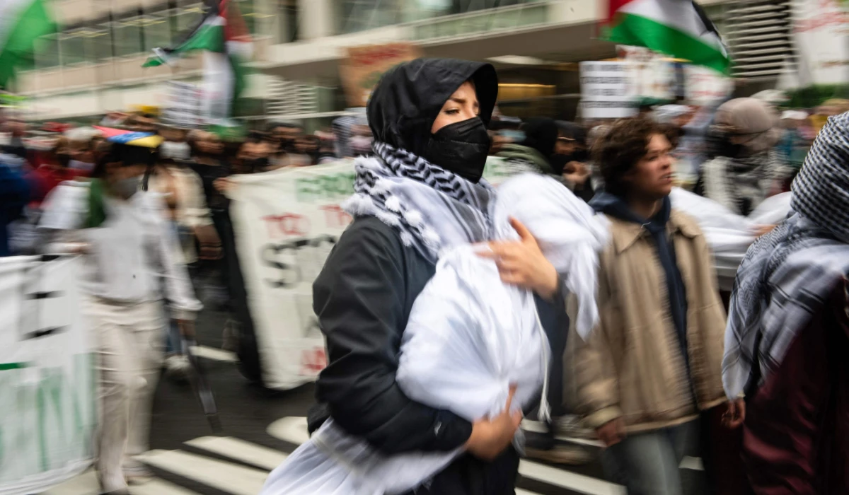 A pro-Palestinian protester holds a mock body as she marches from Philadelphia City Hall to University of Drexel Campus where they set up an encampment as they rally to mark the Nakba anniversary in Philadeplphia, Pennsylvania on May 18, 2024. (AFP)