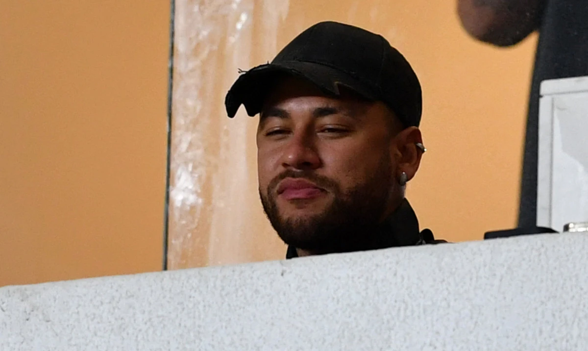 Hilal's Brazilian forward Neymar watches from the stands during the Saudi Super Cup final football match between Al-Ittihad and Al-Hilal at the Mohammed bin Zayed Stadium in Abu Dhabi on April 11, 2024. (AFP)