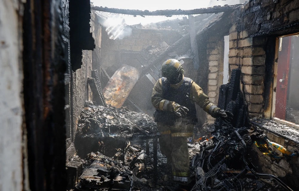 A firefighter works amid debris of a destroyed house in a residential area in Makiivka. (Reuters)