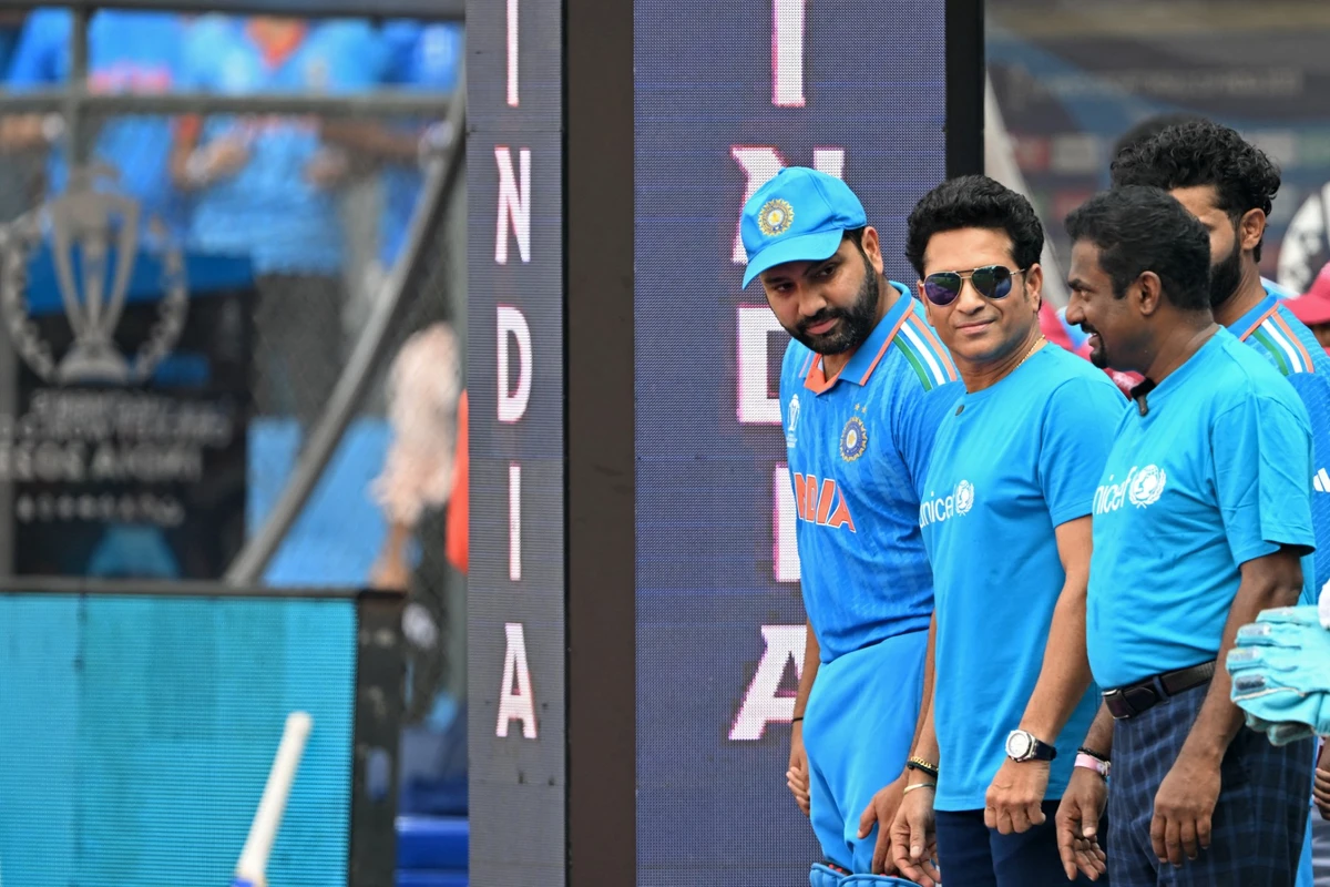 Sri Lanka's former cricketer Muttiah Muralitharan (R) and India's former cricketer Sachin Tendulkar (C) with India's captain Rohit Sharma arrive on the field before the start of the 2023 ICC Men's Cricket World Cup one-day international (ODI) match between India and Sri Lanka at the Wankhede Stadium in Mumbai on November 2, 2023.(AFP)
