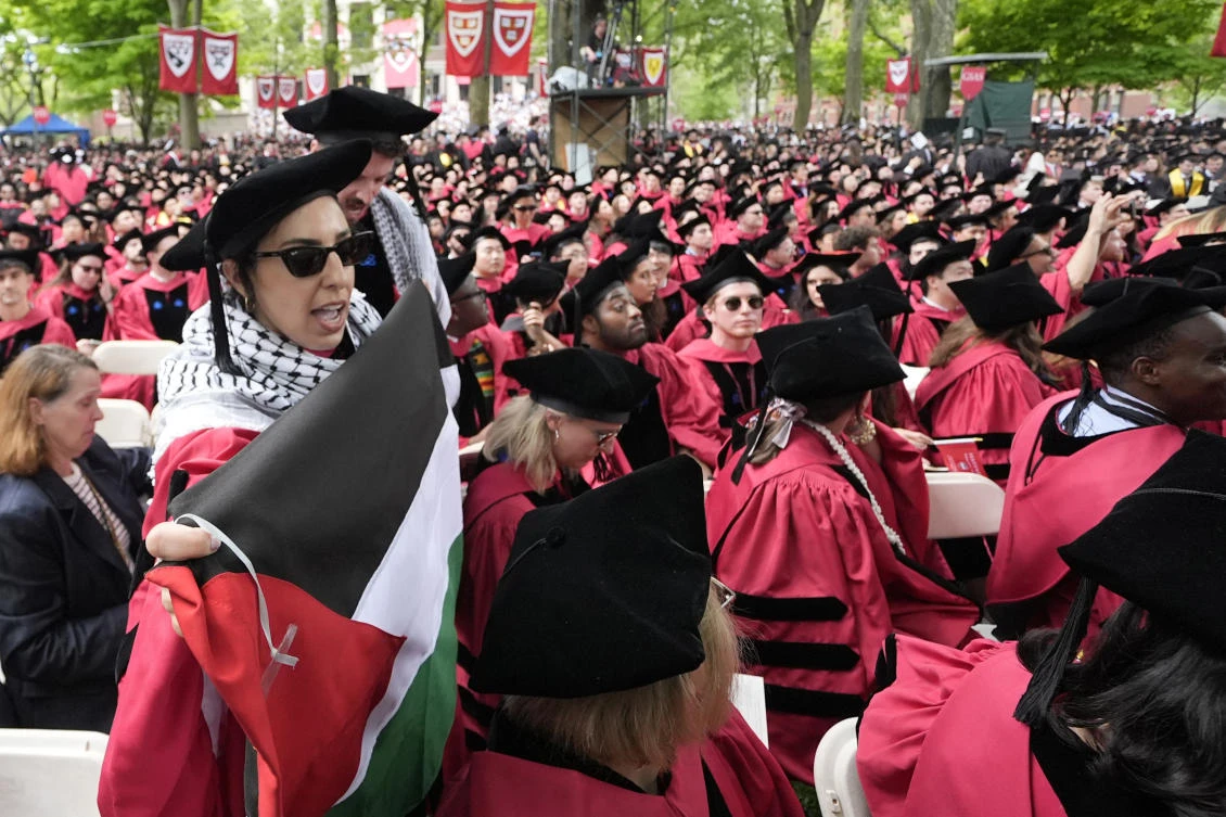 Graduating students chant as they depart commencement in protest to the 13 graduating seniors who were not allowed to participate due to protest activities, in Harvard Yard during commencement at Harvard University on May 23, 2024, in Cambridge. (AP)