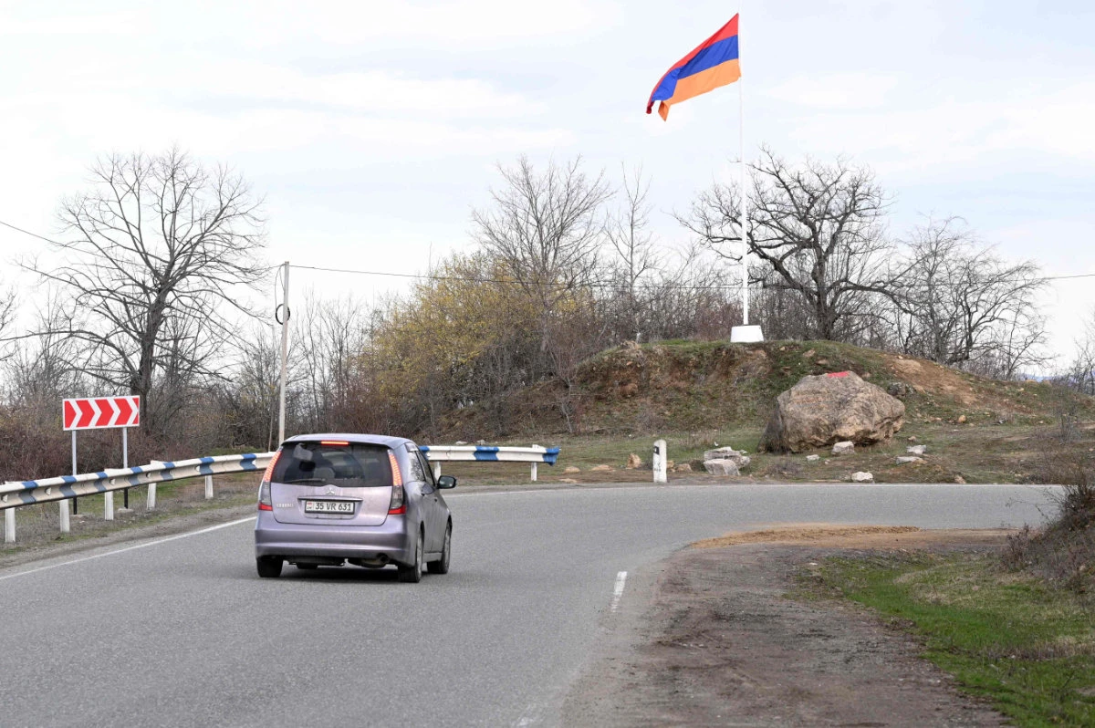 An Armenian flag flies on a roadside outside the village of Voskepar (Azerbaijani name is Ashaghi Askipara) in northeastern Armenia on March 27, 2024. Armenia on May 24, 2024 returned to Azerbaijan four border villages it had seized decades ago, a new step towards normalizing ties between the historic rivals. (AFP)