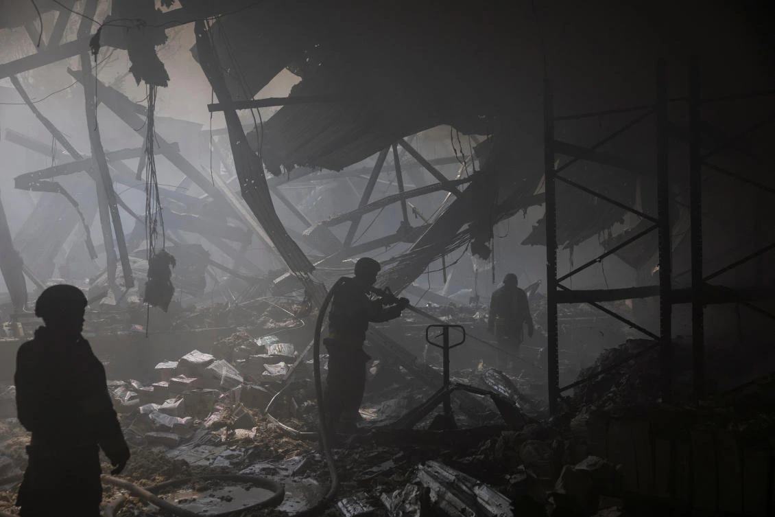 Firefighters work at the site where a printworks was hit by Russian missile strikes in Kharkiv on May 23, 2024. (Reuters)