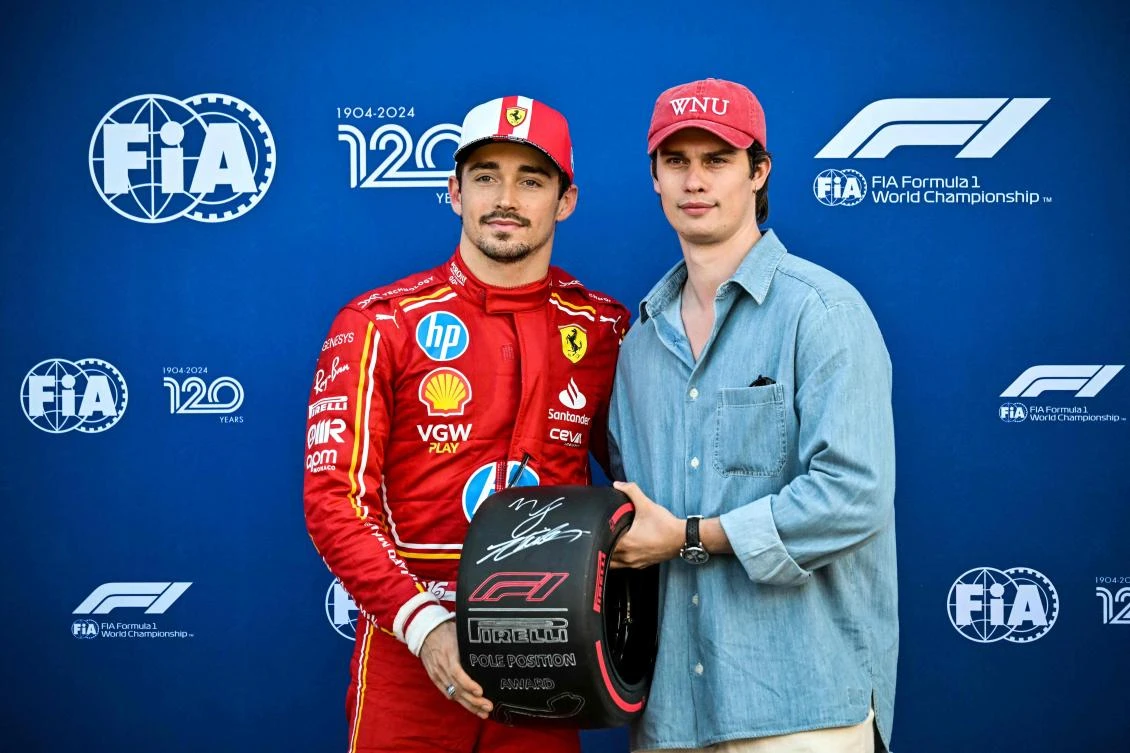 Ferrari’s Monegasque driver Charles Leclerc (L) poses with the Pole Position Award handed over by British singer and actor Nicholas Galitzine (R) after winning the qualifying session of the Formula One Monaco Grand Prix on May 25 2024 at the Circuit de Monaco, on the eve of the race. (AFP)