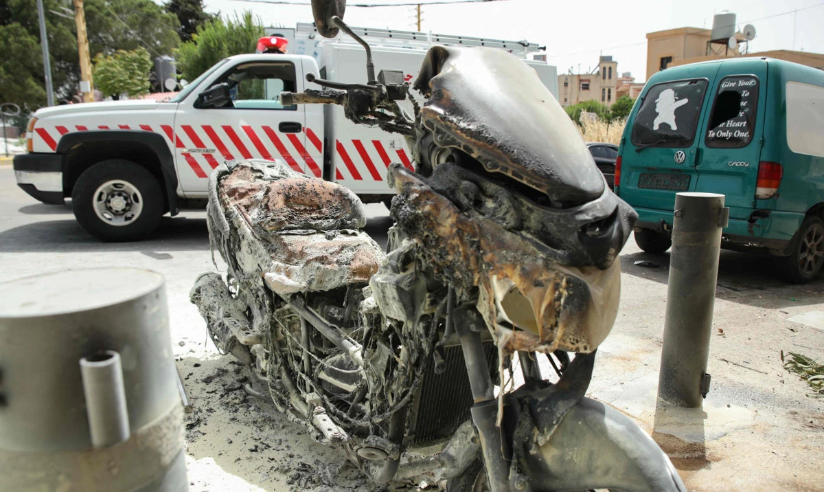 A charred motorbike reportedly hit by an Israeli airstrike is pictured on May 27, 2024 outside the Salah Ghandour Hospital in southern Lebanese town of Bint Jbeil near the border with Israel. (AFP)