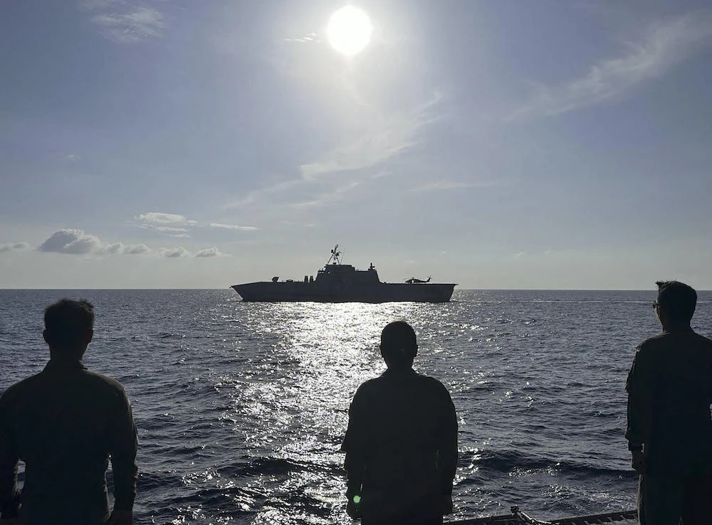 The USS Gabrielle Giffords, top, receives passing honors by Philippine Navy Officers aboard BRP Gregorio Del Pilar during the 3rd AFP-USINDOPACOM Maritime Cooperative Activity in the disputed South China Sea in February 2024. (AFP Western Command/AFP)