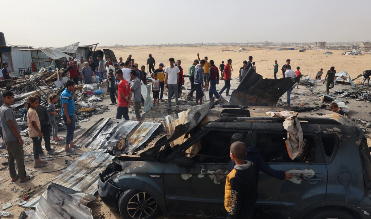 Palestinians gather at the site of an Israeli strike on a camp for internally displaced people in Rafah on May 27, 2024. (AFP)