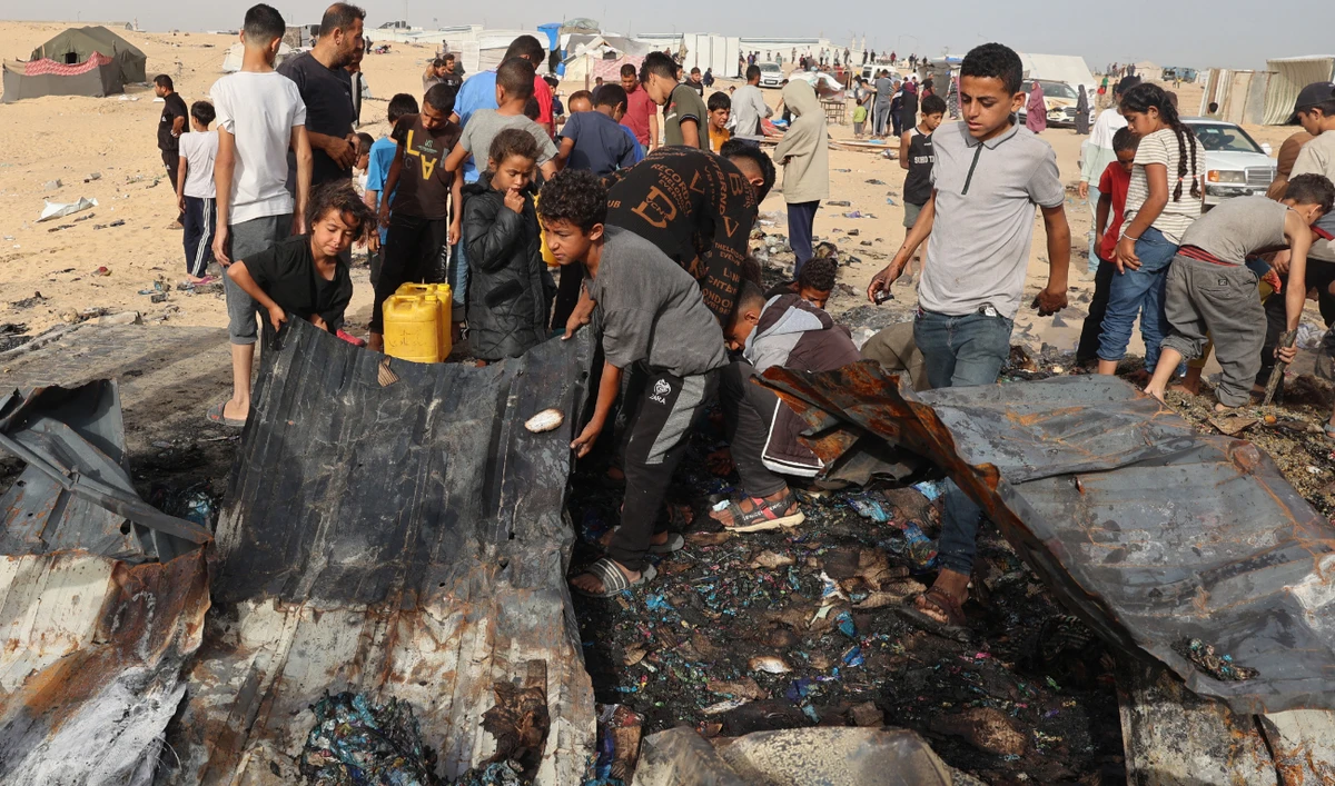 Palestinians gather at the site of an Israeli strike on a camp for internally displaced people in Rafah on May 27, 2024. (AFP)