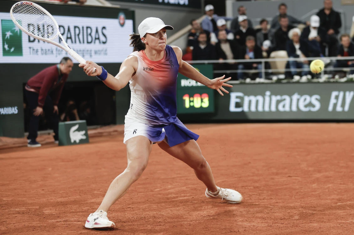 Poland’s Iga Swiatek plays a shot against Japan’s Naomi Osaka during their second round match of the French Open tennis tournament at the Roland Garros stadium in Paris on May 29, 2024. (AP)
