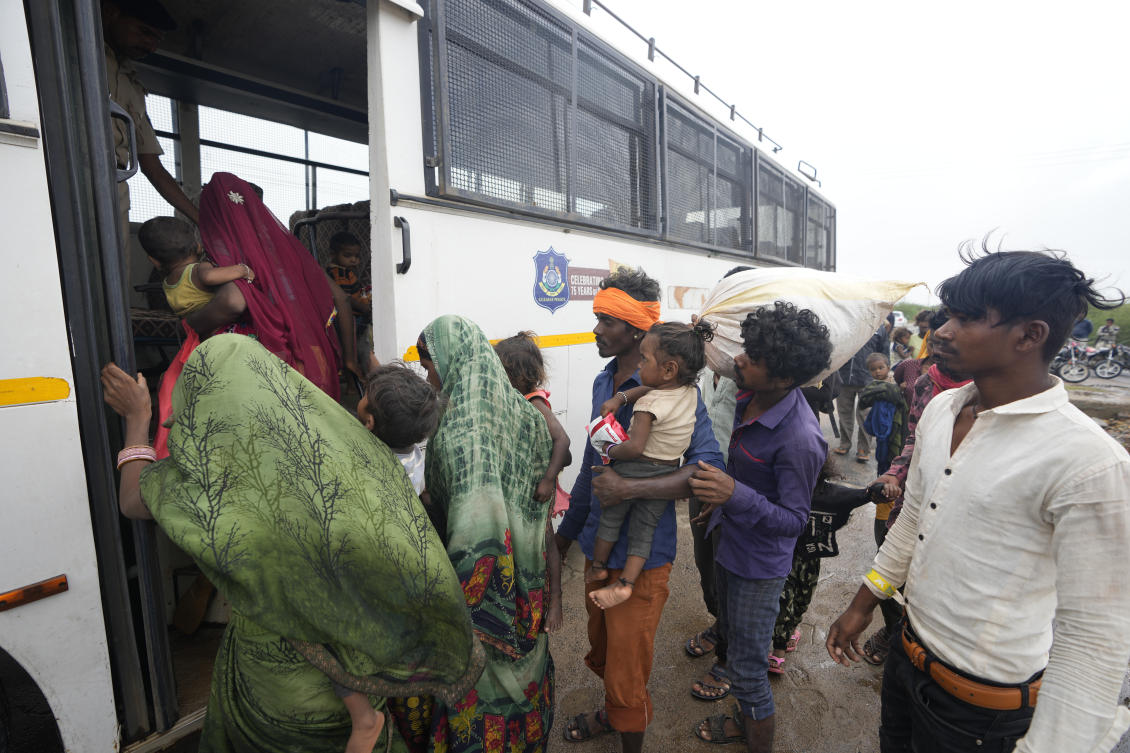 Above, residents being evacuated from a village near Jakhau board a bus to travel to a shelter in Kutch district in India on June 14, 2023. (AP)