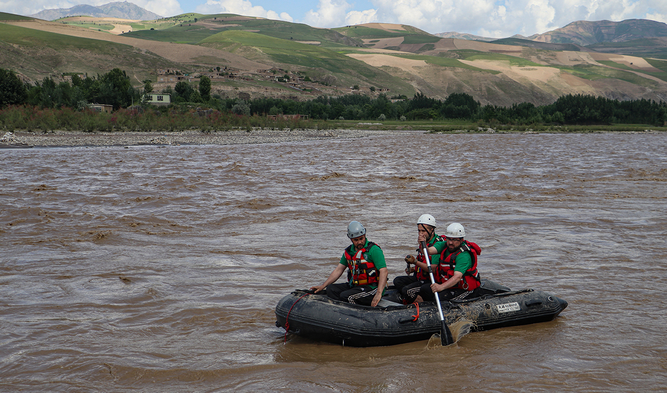 Members of a rescue team search for missing persons in the Kokcha river following flash floods after heavy rainfall, on the outskirts Fayzabad in Badakhshan province on May 26, 2024. (AFP)