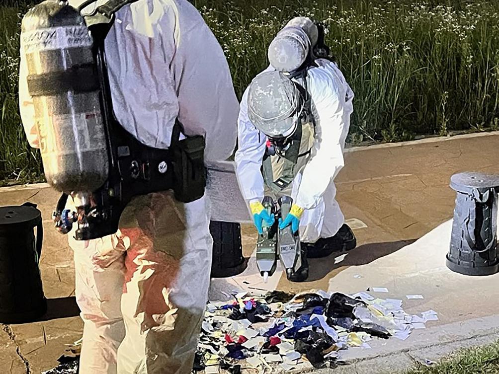South Korean military officers check unidentified objects, believed to be North Korean trash from balloons that crossed the inter-Korea border, on a street in Seoul on June 1. (South Korean Defense Ministry/AFP)