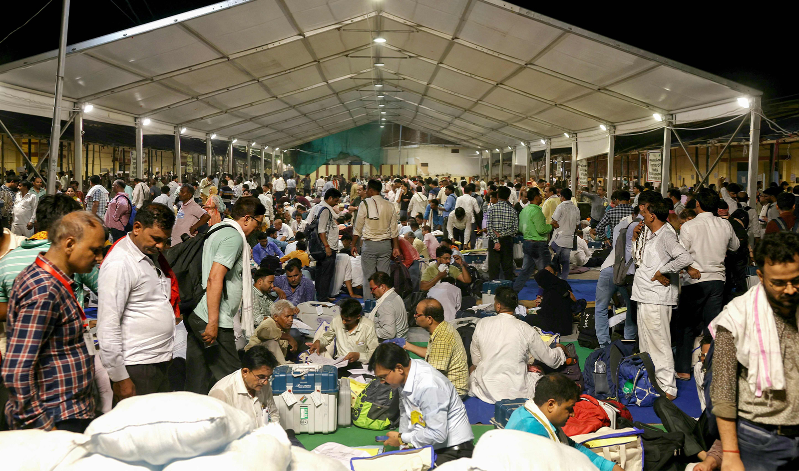 Polling officials gather to submit electronic voting machines (EVMs) and other polling materials at a collection centre in Varanasi on June 1, 2024, at the end of the seventh and final phase of voting in India's general election. (AFP)
