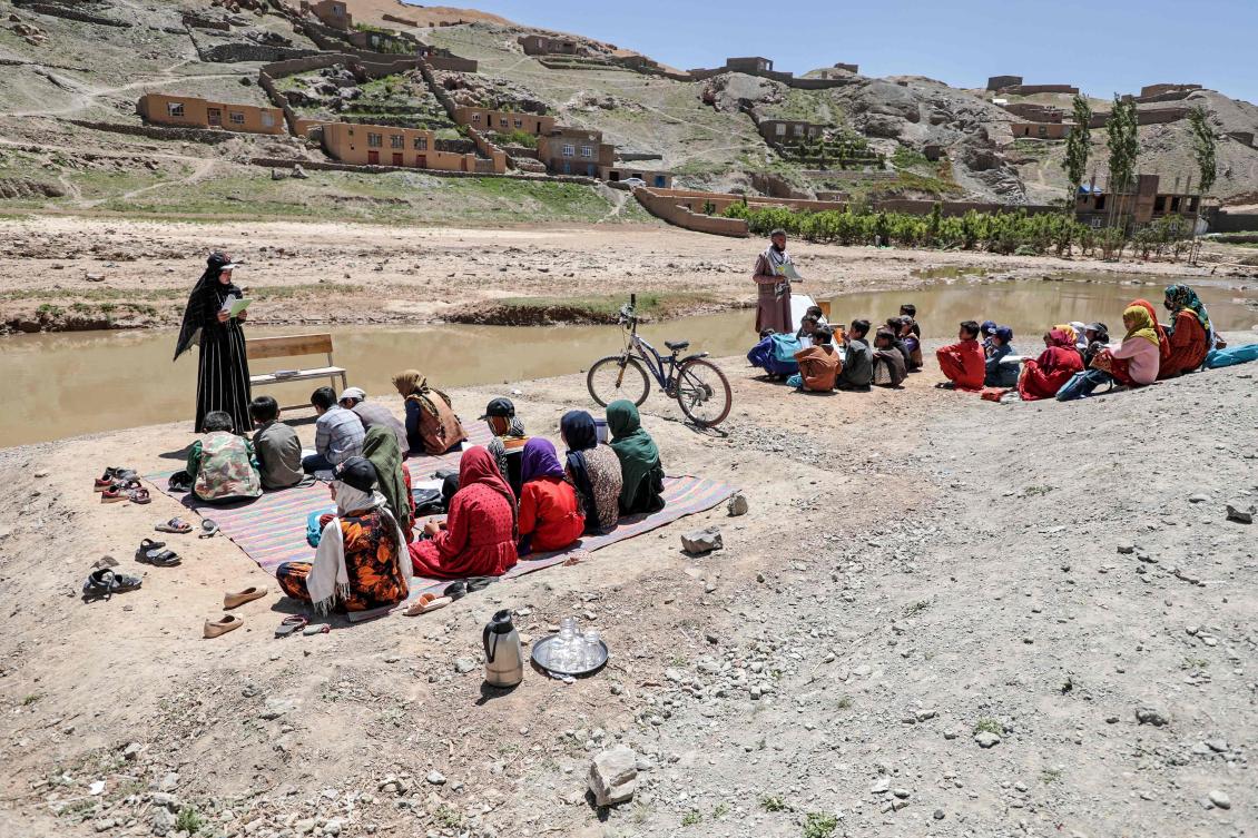 Flash flood affected Afghan children attend an open-air school in Firozkoh of Ghor province on May 30, 2024. (AFP)