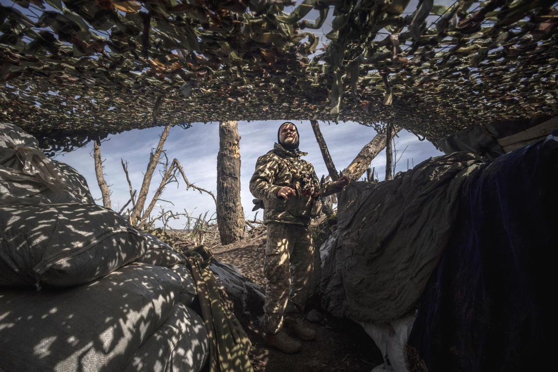 Infantry soldier Viktor of Ukraine's 58th Motorized Brigade scans the sky for enemy drones as he stands in a frontline trench in the Donetsk region. (REUTERS)