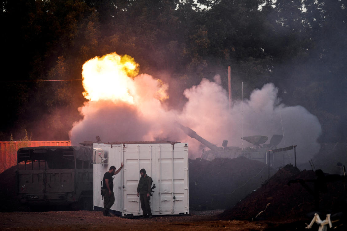 Israeli soldiers stand by, as a mobile artillery unit fires on the Israeli side of the Israel-Lebanon border December 2, 2023. (Reuters)