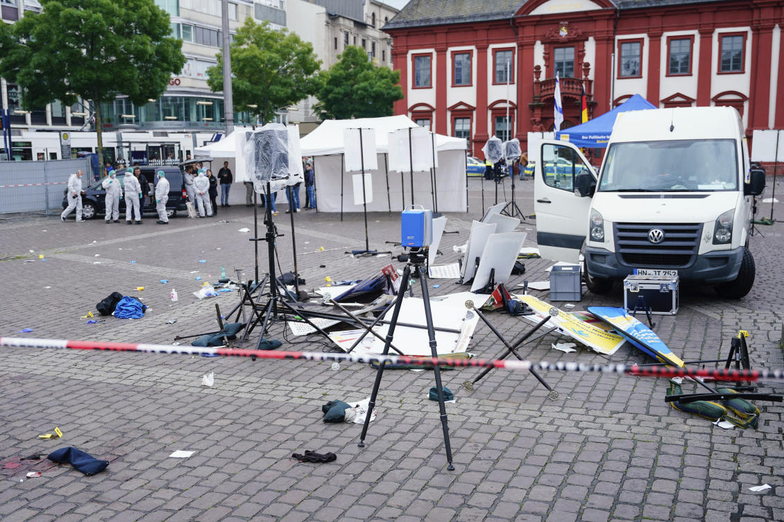 Forensics officers stand behind a smashed stall on the market square in Mannheim, Germany, Friday, May 31, 2024. An assailant with a knife attacked and wounded several people in a central square in the southwestern German city of Mannheim on Friday, police said. Police shot the attacker, who also was hurt. (AP)