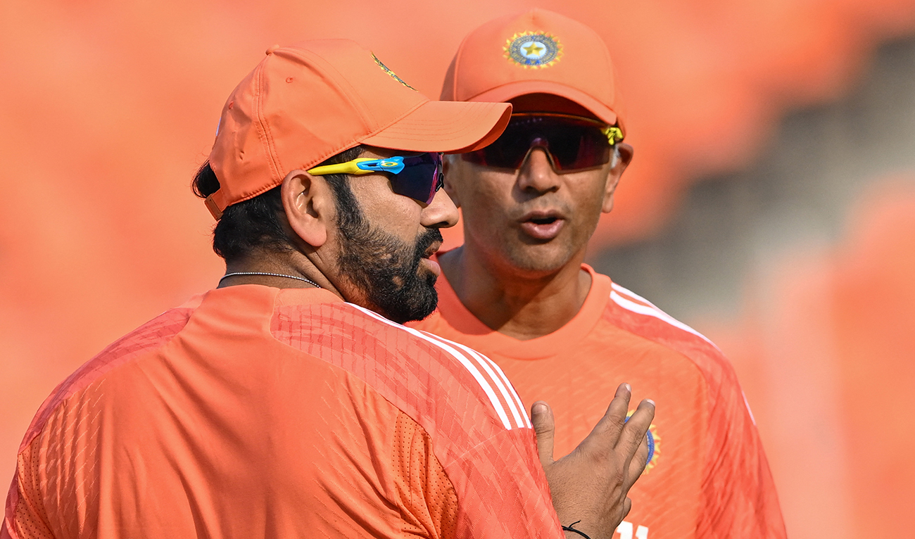 India’s captain Rohit Sharma (L) interacts with coach Rahul Dravid during a practice session at the Narendra Modi Stadium in Ahmedabad on November 17, 2023. (AFP/File)