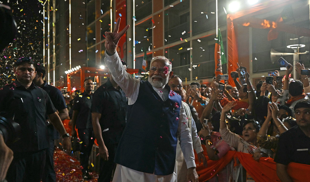 India’s Prime Minister Narendra Modi (C) flashes victory sign as he arrives at the Bharatiya Janata Party (BJP) headquarters to celebrate the party’s win in country's general election, in New Delhi on June 4, 2024. (AFP)