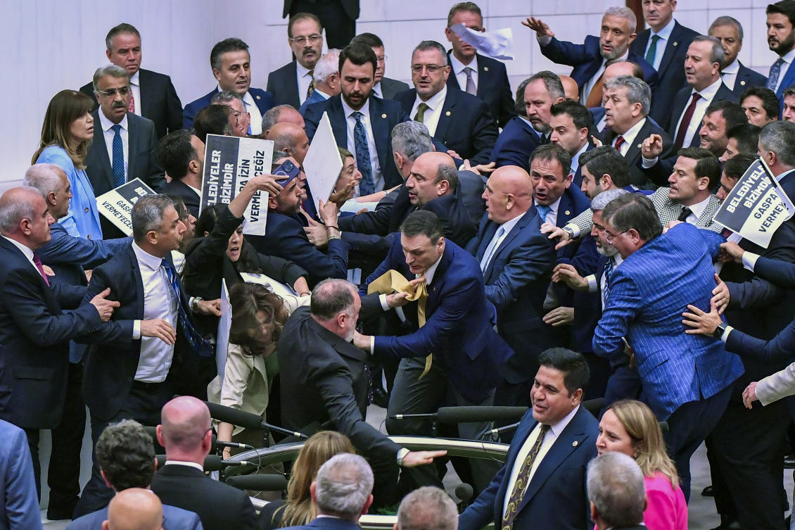 Pro-Kurdish Peoples’ Equality and Democracy Party, or DEM, and Justice and Development Party, or AKP, lawmakers scuffle at the parliament in Ankara, Tuesday, June 4, 2024. (AP Photo)