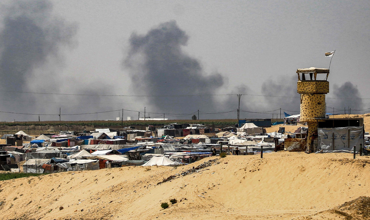 Smoke plumes billow near tents sheltering displaced Palestinians in Rafah in the southern Gaza Strip on June 4, 2024 amid the ongoing conflict in the Palestinian territory between Israel and Hamas. (AFP)