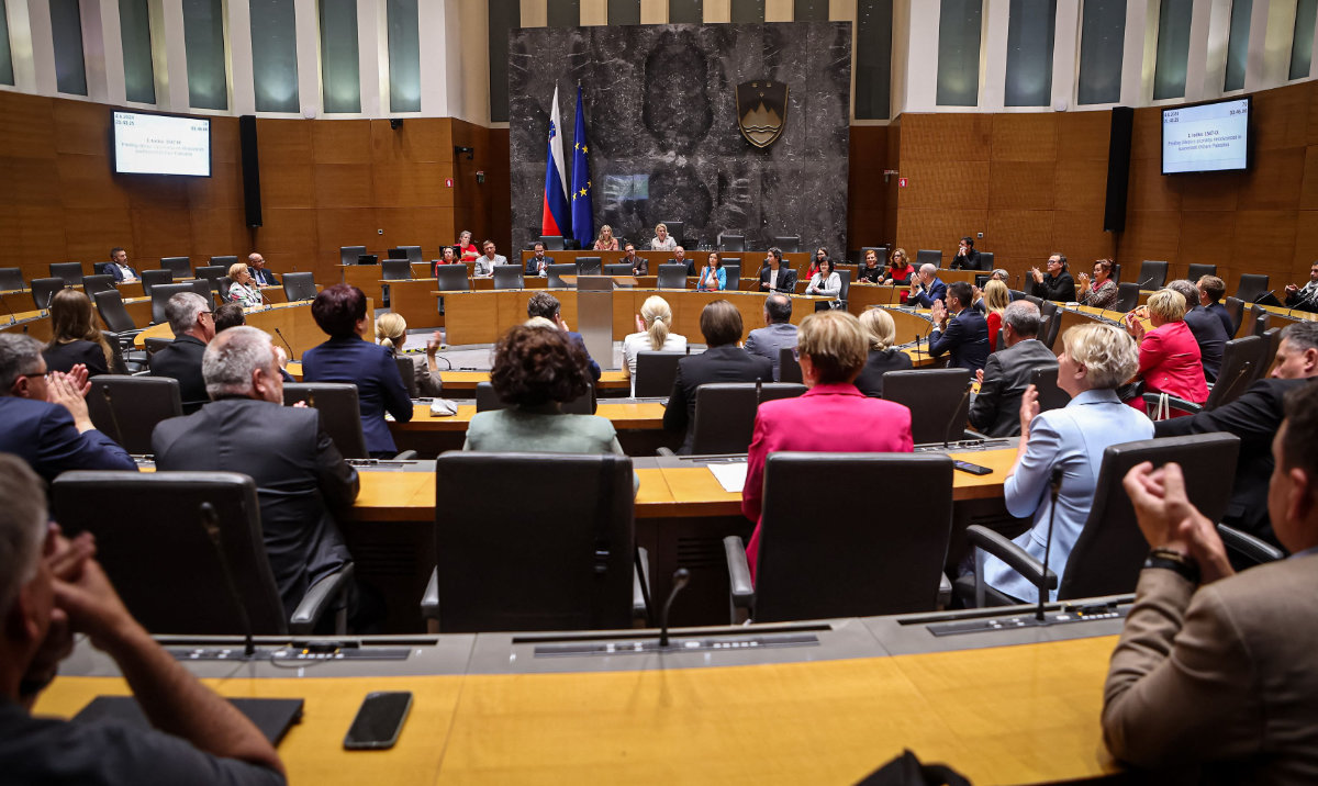 Members of the National Assembly applaud after the parliamentary vote in favor of recognizing a Palestinian state, in Ljubljana, on June 4, 2024. (AFP)